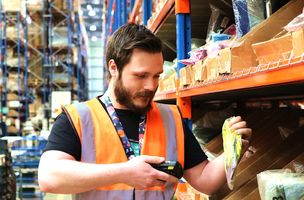 A Whist Fulfilment employee picks and scans a customer order. 