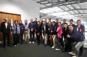 Delegates from the Cheung Kong Graduate School of Business smile alongside their hosts from Whistl