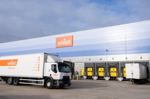 A Whistl truck travels past loading bays in Bedford