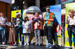 Relish sustainable fashion show, with people in the created outfits standing on stage 