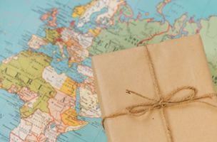 map with a brown parcel with brown twine in a bow 