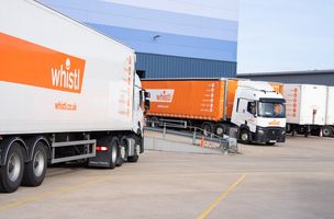 Whistl lorries in orange and white livery parked at Bedford depot