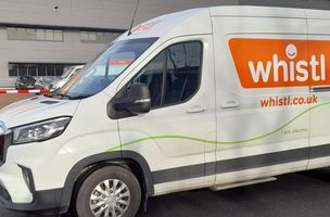 whistl.co.uk branded white electric van parked in front of depot