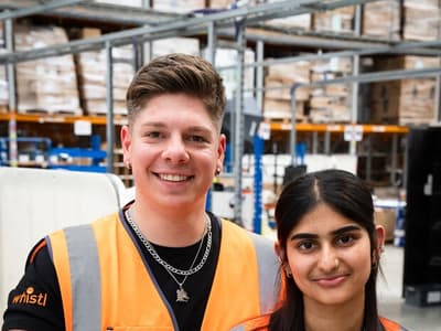Two Whistl employees in a fulfilment warehouse