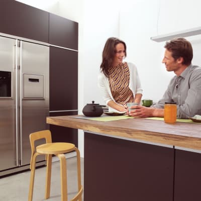  couple drinking coffee in a kitchen 